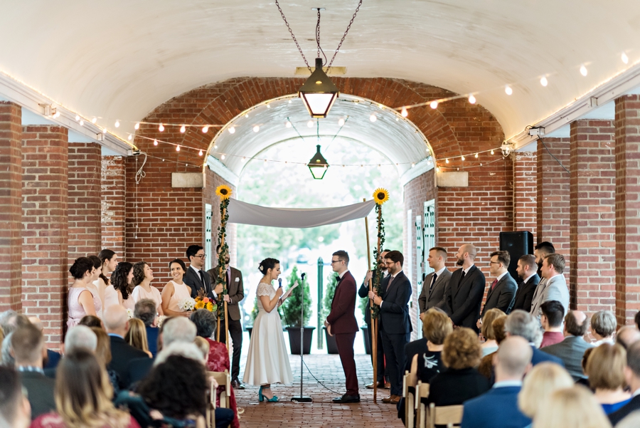 A wedding ceremony under the Chuppah and string lights at The Shambles in the Headhouse district in Philadelphia.